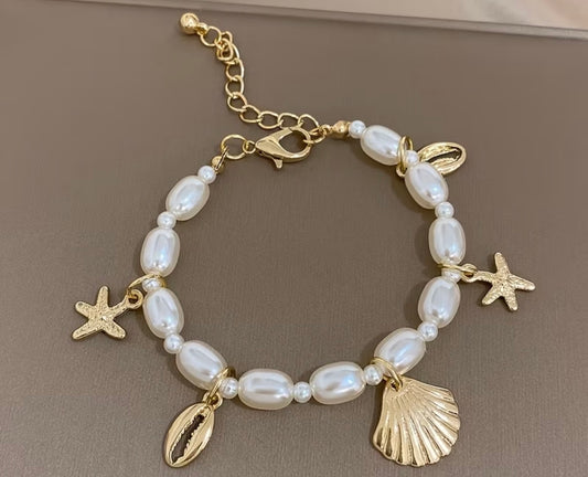 Ocean Charm Pearl Bracelet – Gold Shell & Starfish Design